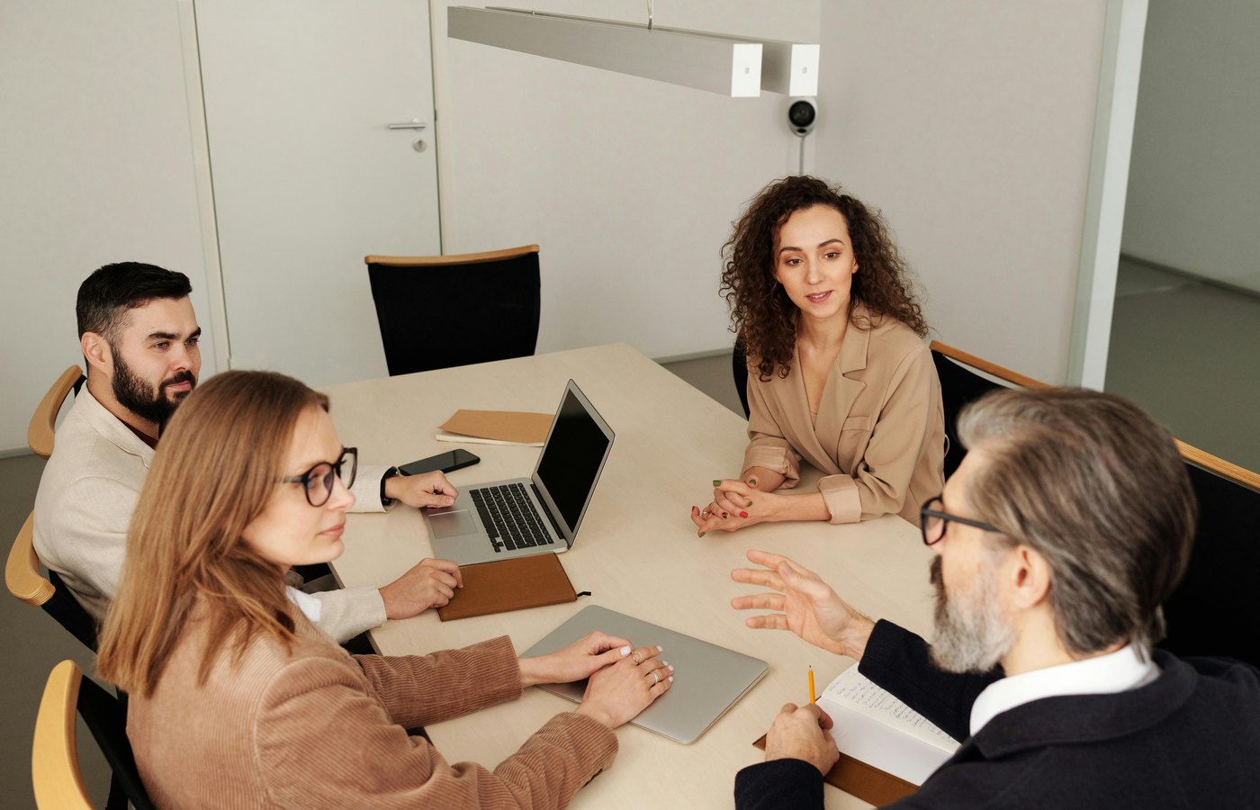 People discussing event requirements in a meeting room